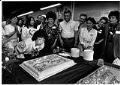 Image of Dolores Sibonga blowing out birthday candles at her campaign offices, Seattle, August 28, 1989
