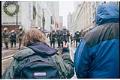 Image of Kneeling demonstrators facing police line at WTO protest, Seattle, December 1, 1999