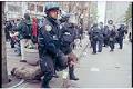 Image of Police officers holding demonstrator at WTO protest, Seattle, December 1, 1999