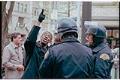Image of Man speaking with police officers at WTO protest, Seattle, December 3, 1999