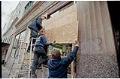 Image of Workers covering store windows prior to WTO protests, Seattle, December 3, 1999