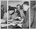 Image of Jung Oy Chinn signing U.S. naturalization papers, Seattle, September 17, 1951
