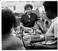 Image of Ruth Velozo sorting food with volunteers at Northwest Second Harvest, Seattle, August 3, 1983