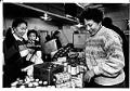 Image of Kuuseng Sateurn and Lai Sio receiving goods from Ruth Velozo at Northwest Harvest, Seattle, December 27, 1990
