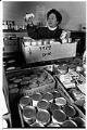 Image of Ruth Velozo checking cans of food at Northwest Harvest, Seattle, November 18, 1991