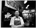 Image of Tony Wong in front of his store at Pike Place Market, Seattle, September 28, 1982