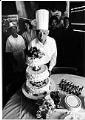 Image of Henry Woo blowing out birthday candles at Linyen Restaurant & Lounge, Seattle, July 11, 1982