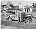 Image of Joe Smith standing in front of  his station wagon, Seattle, circa 1950