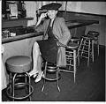 Image of Woman seated at the Black and Tan bar, Seattle, July 28, 1945