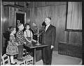 Image of Children watching rabbi light menorah candle, December 3, 1961