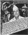 Image of Anwar Aboul Hosn with tray of baklava, December 1977