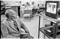Image of Ahmed Isse looking at photographs at Red Cross headquarters, Seattle, December 28, 1992
