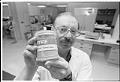 Image of Joseph P. Balint Jr. holding Prosorba Column device at IMRE Corp., Seattle,  March 22, 1993