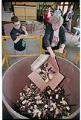 Image of Woman dumping guns into foundry crucible, Seattle, June 16, 1993