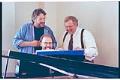 Image of Harvey Fierstein, Evan Stults, and Dennis Coleman around piano, Seattle, June 22, 1993