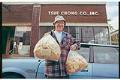 Image of Customer with bags of fortune cookie wafers outside Tsue Chong Co., Seattle, July 18, 1993
