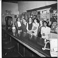 Image of Six people posing behind a bar, Seattle, circa 1944