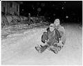 Image of Butch & Izzy Smith riding on a sled, Seattle, circa 1950