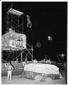 Image of Stunt cowboy jumping off of  platform at rodeo, 1962