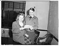 Image of Betty Morrison and Thomas Morrison holding their naturalization papers, December 22, 1947