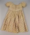 Image of Child's dress with brown and red berry pattern, ca. 1850