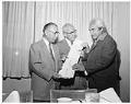 Image of Joseph Hillaire (Kwul-kwul'tw) showing totem pole sketch to William Devin and Genji Mihara, Seattle, June 1961