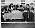Image of Sallie Onishi cutting cake for her young students, Japanese Baptist Church, Seattle, July 1, 1948
