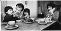 Image of Soukasone and Vilae family at table, Bellevue, July 19, 1981