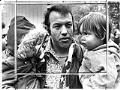 Image of Leroy Mills carrying two children at protest, Seattle, October 14, 1975