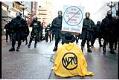 Image of Seated protester facing police line at WTO protest, Seattle, November 30, 1999