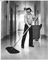 Image of Thien Dac Nguyen mopping floor, Seattle, February 18, 1976
