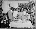 Image of Party-goers posing together by a birthday cake, Seattle, circa 1945