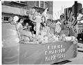 Image of Mardi Gras royalty riding on a parade float, August 5, 1952