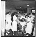 Image of Marie Edwards with her beauty school students, Seattle, circa 1955