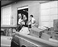 Image of Men delivering boxes of goods for shipment to migrant farm workers, Seattle, August 21, 1967