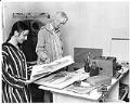 Image of William & Sue Cumming looking at art work in home studio, May 1971