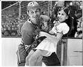 Image of Victor Kuzkin carrying Annette Daggett before Totems-USSR hockey game, December 25, 1972