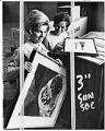 Image of Two Seattle Junior League members with art works, Seattle, April 1971