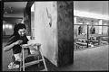 Image of Mary Ann Peters painting mural in Port of Seattle building, February 14, 1993