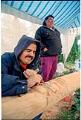 Image of Lummi carvers Verne Johnson Jr. (Tsow-sum) and Ken Cooper working on totem pole, October 21, 1993
