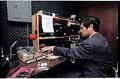 Image of Quốc Nam choosing music for Saigon Radio, Seattle, August 21, 1996