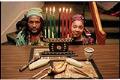 Image of Man and woman with Kwanzaa candles and other symbolic items at Langston Hughes Center, Seattle, December 20, 1996