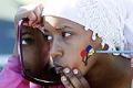 Image of Chaltu Abdela having her face painted at Juneteenth celebration, Seattle, June 19, 2001