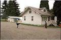 Image of Boy kicking soccer ball outside the Masjid Al-Salaam mosque building, SeaTac, August 3, 2001