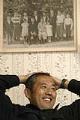 Image of Steve Sakuma with portrait of his grandparents and their children, Burlington, Washington, June 27, 2002