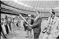 Image of Ted Williams holding bat during tour of the Kingdome, January 1976