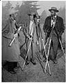 Image of Three photographers with cameras outdoors, circa 1950