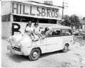 Image of Two children sitting on car in front of Hills Bros. BBQ, Seattle, circa 1953