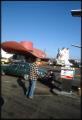 Image of Customer getting gas at the Hat 'n' Boots Texaco station, Seattle, 1985