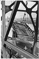 Image of Men watching large section being lifted by a crane at Todd Pacific Shipyards, Seattle Division, circa 1945